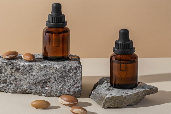 minimal background of argan oil care composition